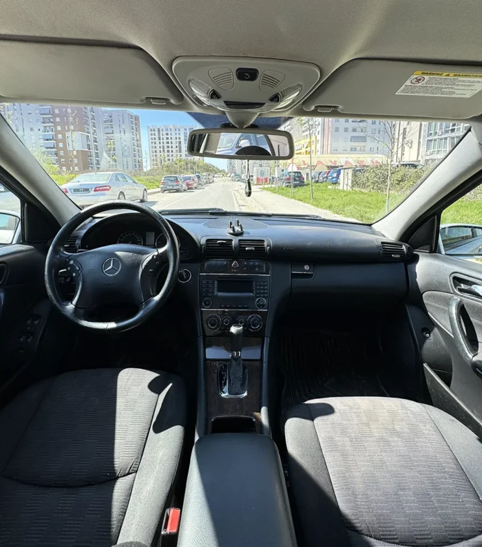 Interior of 2007 Mercedes C-Class 2.2 CDI automatic executive saloon showing front seats, steering wheel and centre console in Tirana