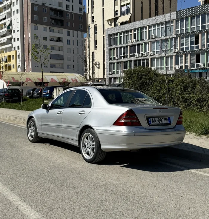 Silver Mercedes C-Class 2007 2.2 CDI executive saloon rear three-quarter view parked on a street in Albania