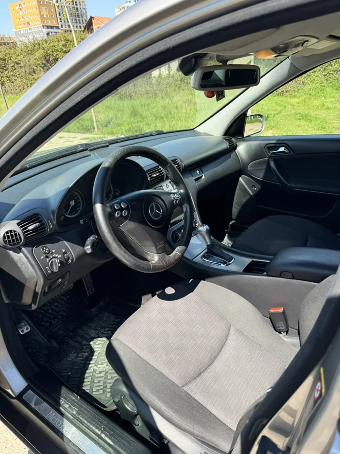 Driver’s seat, steering wheel and dashboard of grey Mercedes C-Class 2007 2.2 diesel automatic sedan