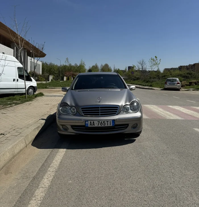 Front view of grey Mercedes C-Class 2007 2.2 diesel automatic sedan stopped near a pedestrian crossing
