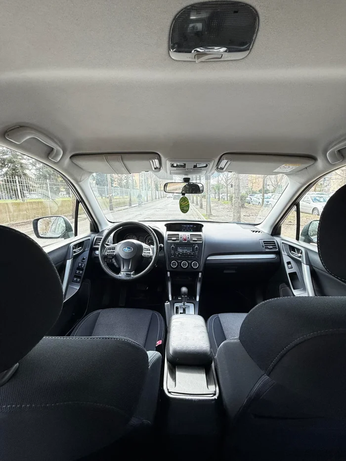 Interior of Subaru Forester 2015 showing front seats, steering wheel and automatic gearbox