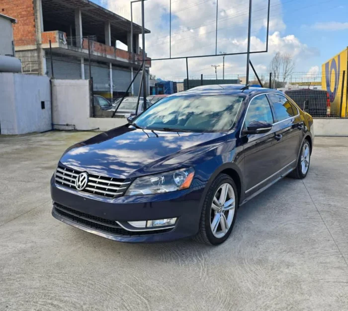 Front angle view of dark blue VW Passat SEL 2013 TDI diesel rental car available for pickup at Tirana airport