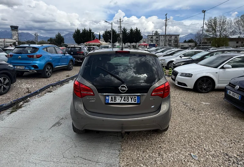 Opel Meriva 2012 - 2.0 Diesel Manual 7 Seater with Panoramic Sunroof Rental in Tirana Albania 5 - Car Rent in Albania Grey Opel Meriva 2012 2.0 diesel manual compact MPV with panoramic sunroof and dark interior parked near Tirana International Airport Rinas