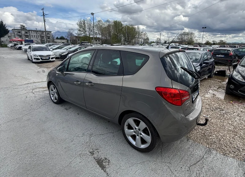 Opel Meriva 2012 - 2.0 Diesel Manual 7 Seater with Panoramic Sunroof Rental in Tirana Albania 4 - Car Rent in Albania Grey Opel Meriva 2012 2.0 diesel manual compact MPV with panoramic sunroof and dark interior parked near Tirana International Airport Rinas