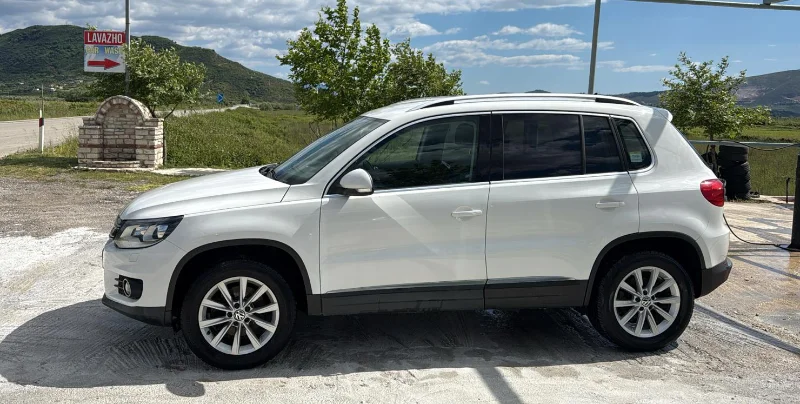 Volkswagen Tiguan 2014 - 2.0 TDI Diesel Automatic 4x4 SUV Rental in Tirana Albania 2 - Car Rent in Albania White Volkswagen Tiguan 2014 2.0 TDI diesel automatic 4x4 SUV parked in the Albanian countryside, available for rental from Tirana and Tirana Airport Rinas