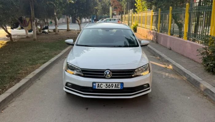 White Volkswagen Jetta 2015 2.0 TDI automatic diesel sedan parked in Tirana, available for car rental in Albania with TiRental