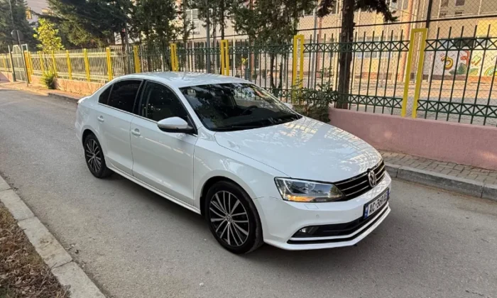 White Volkswagen Jetta 2015 2.0 TDI automatic diesel sedan parked in Tirana, available for car rental in Albania with TiRental
